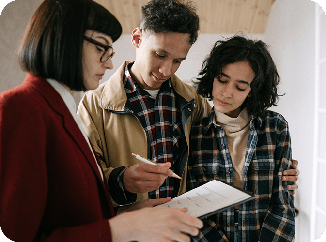 Couple looking at contract with realtor
