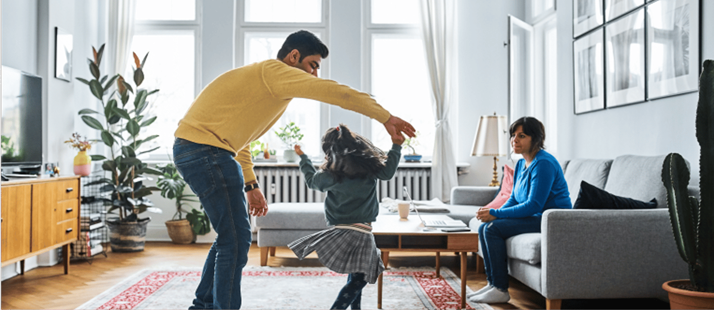 Couple in living room dancing