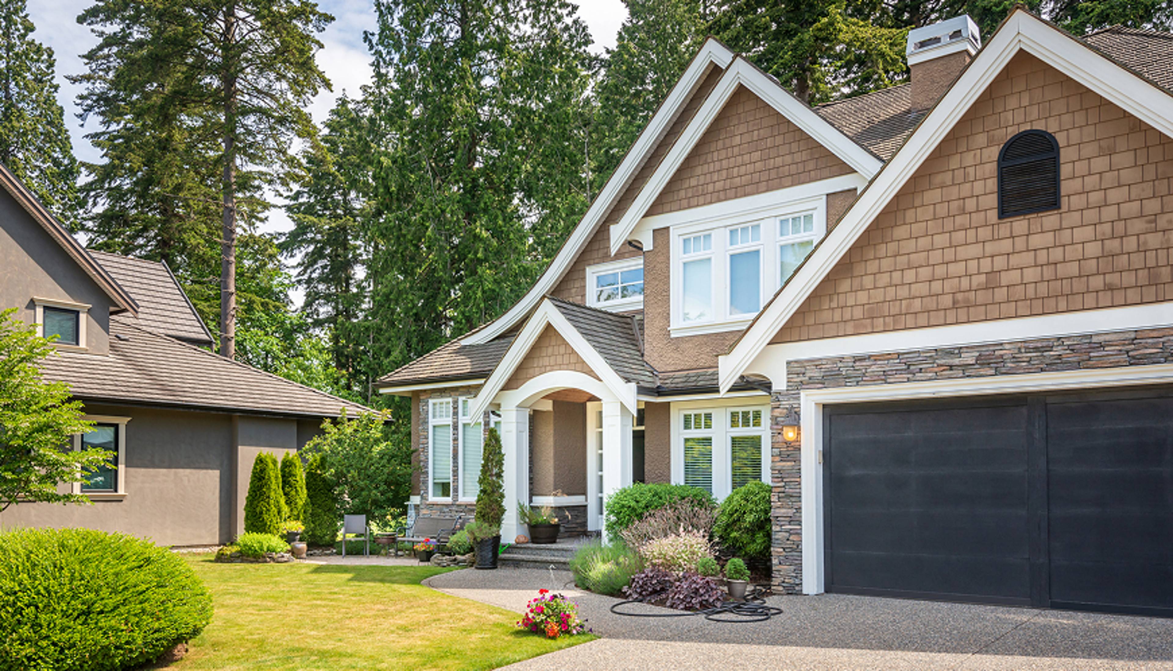 A two-story brick house with a garage attached.