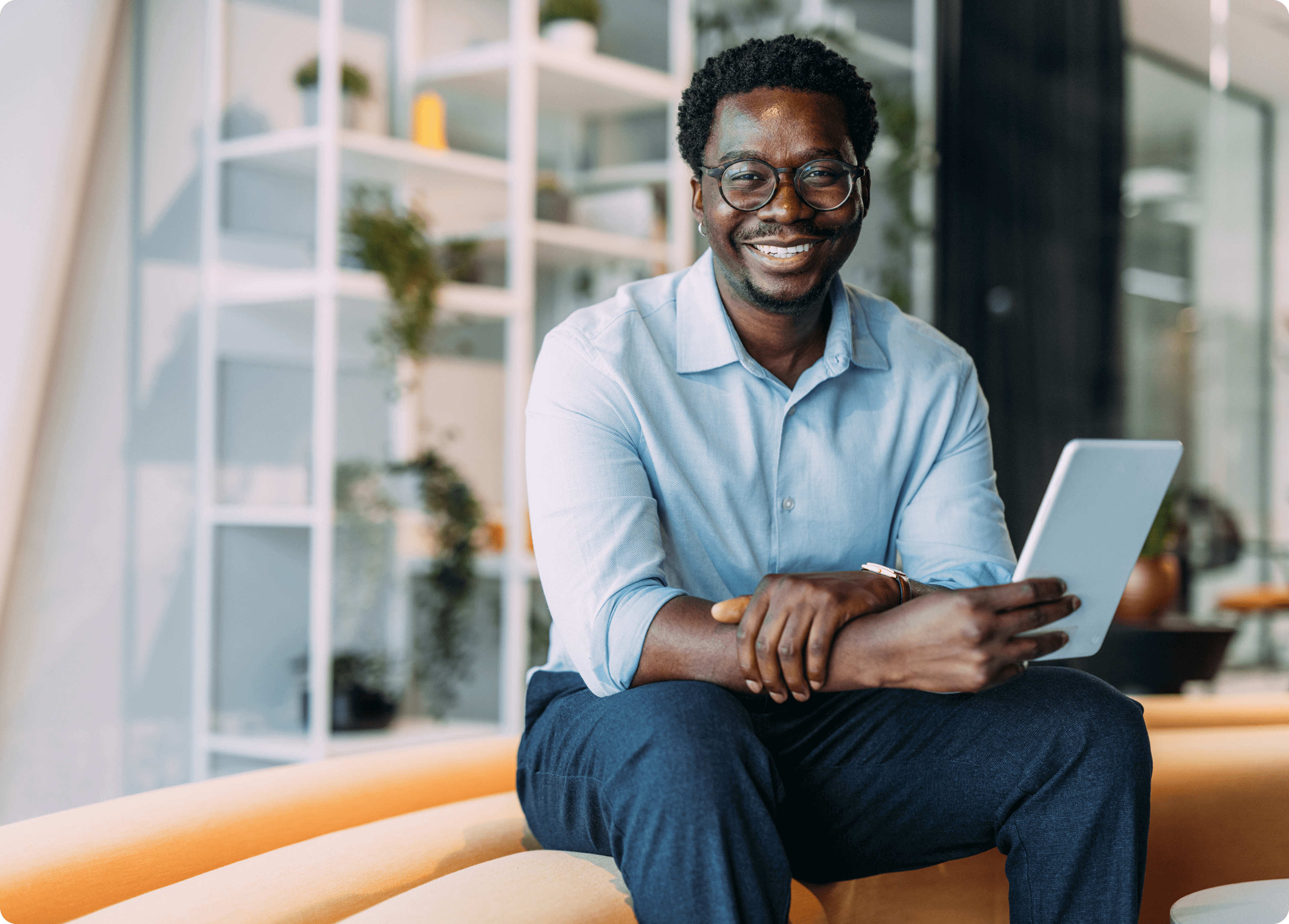Rate Correspondent - Man sitting smiling.