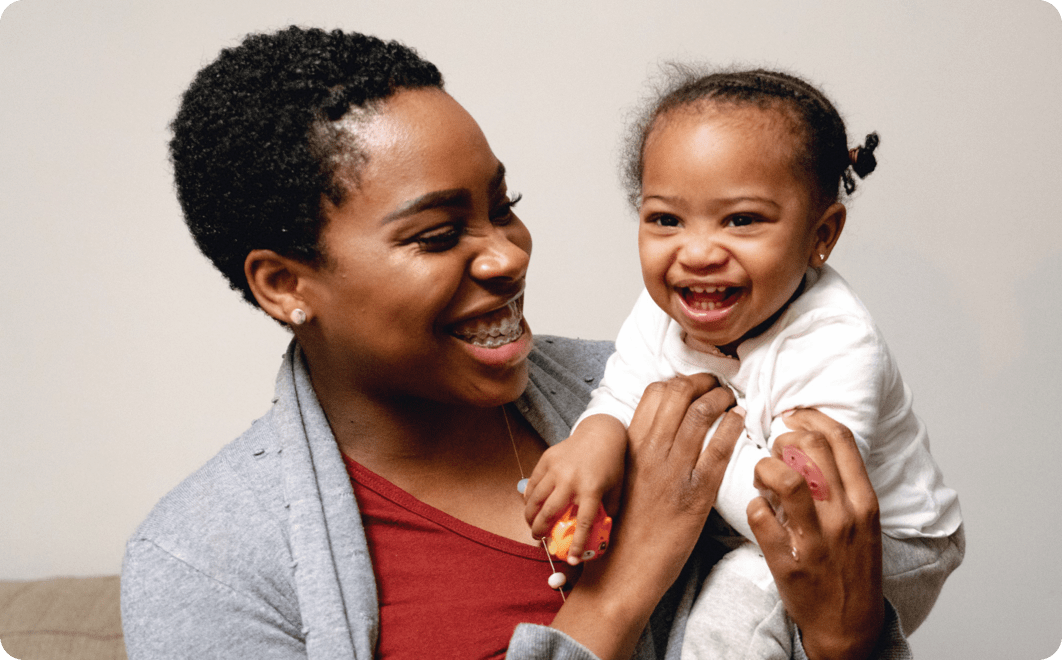 A woman holding an infant child.