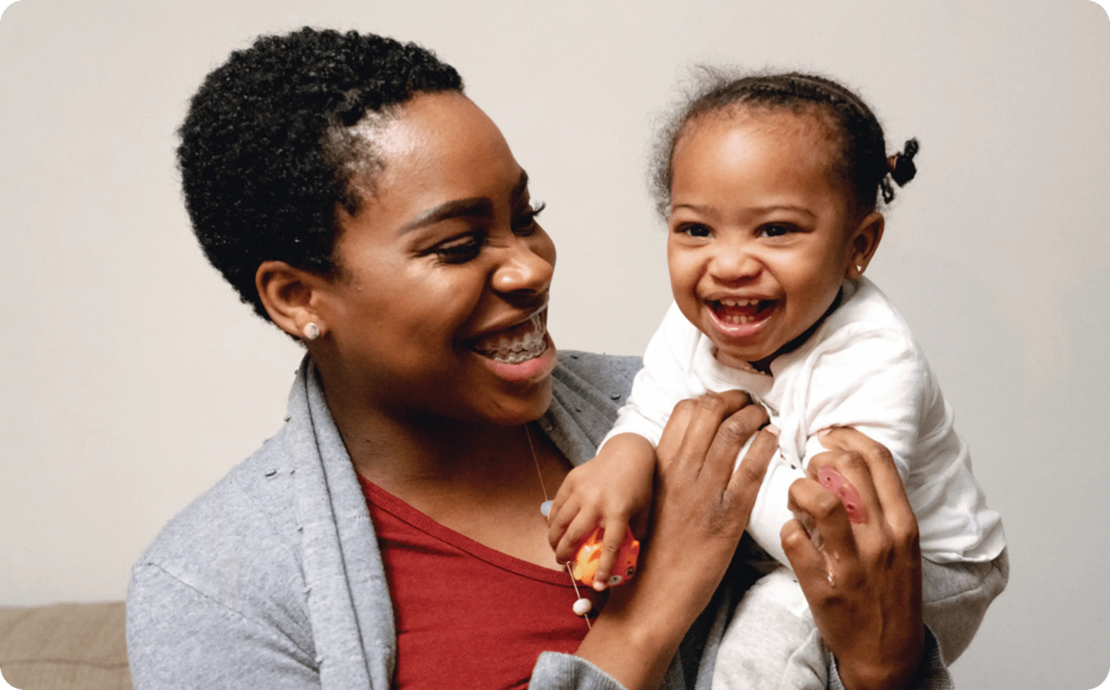 A woman holding an infant child.