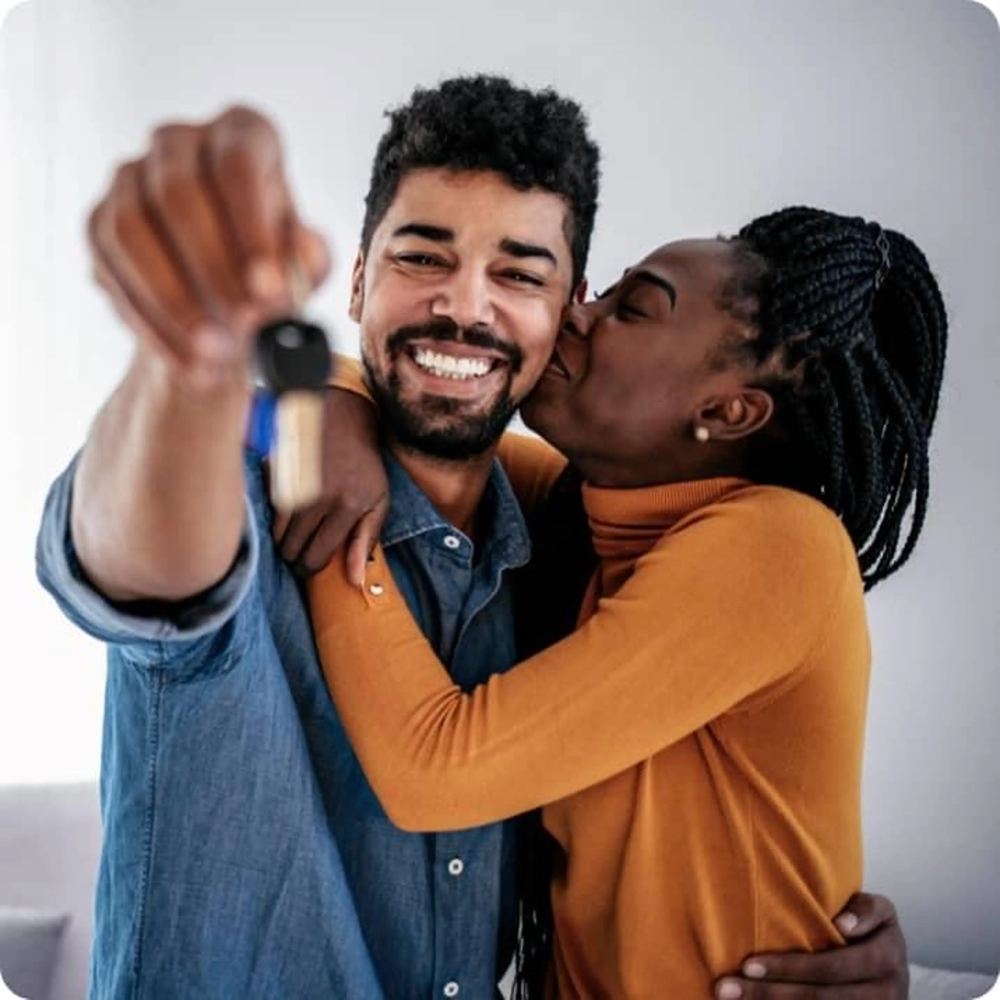 FTHB - A couple celebrating and holding the keys to their new home.