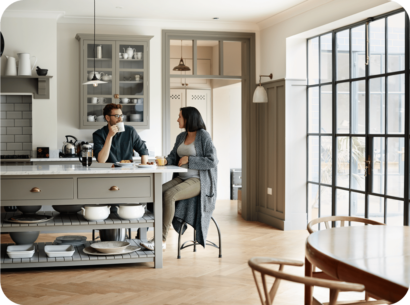 2 people sitting at an island