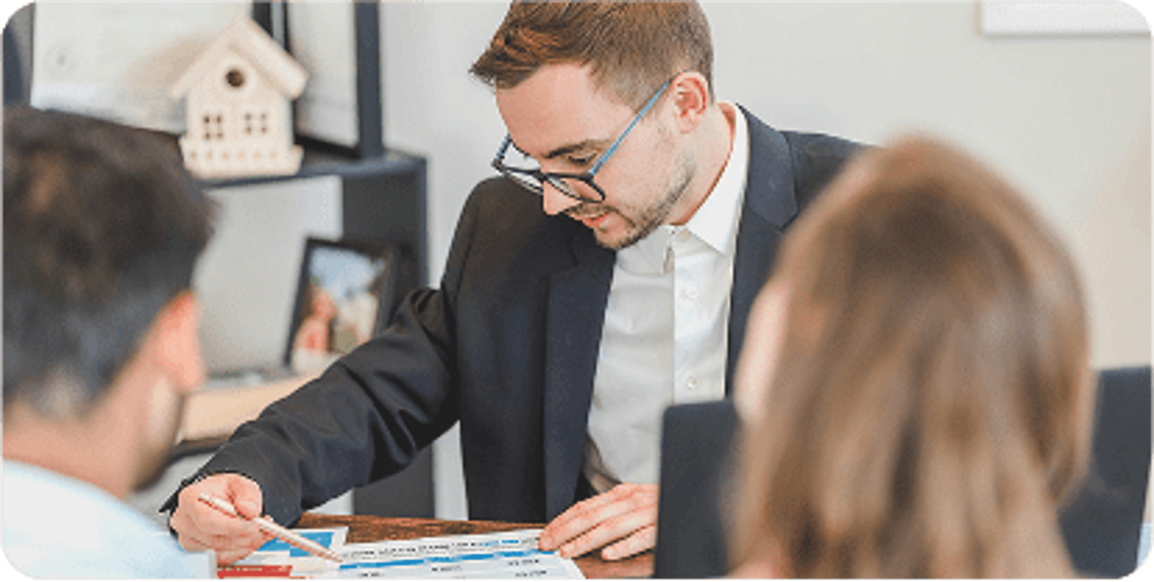 A financial advisor looks over paperwork with a couple