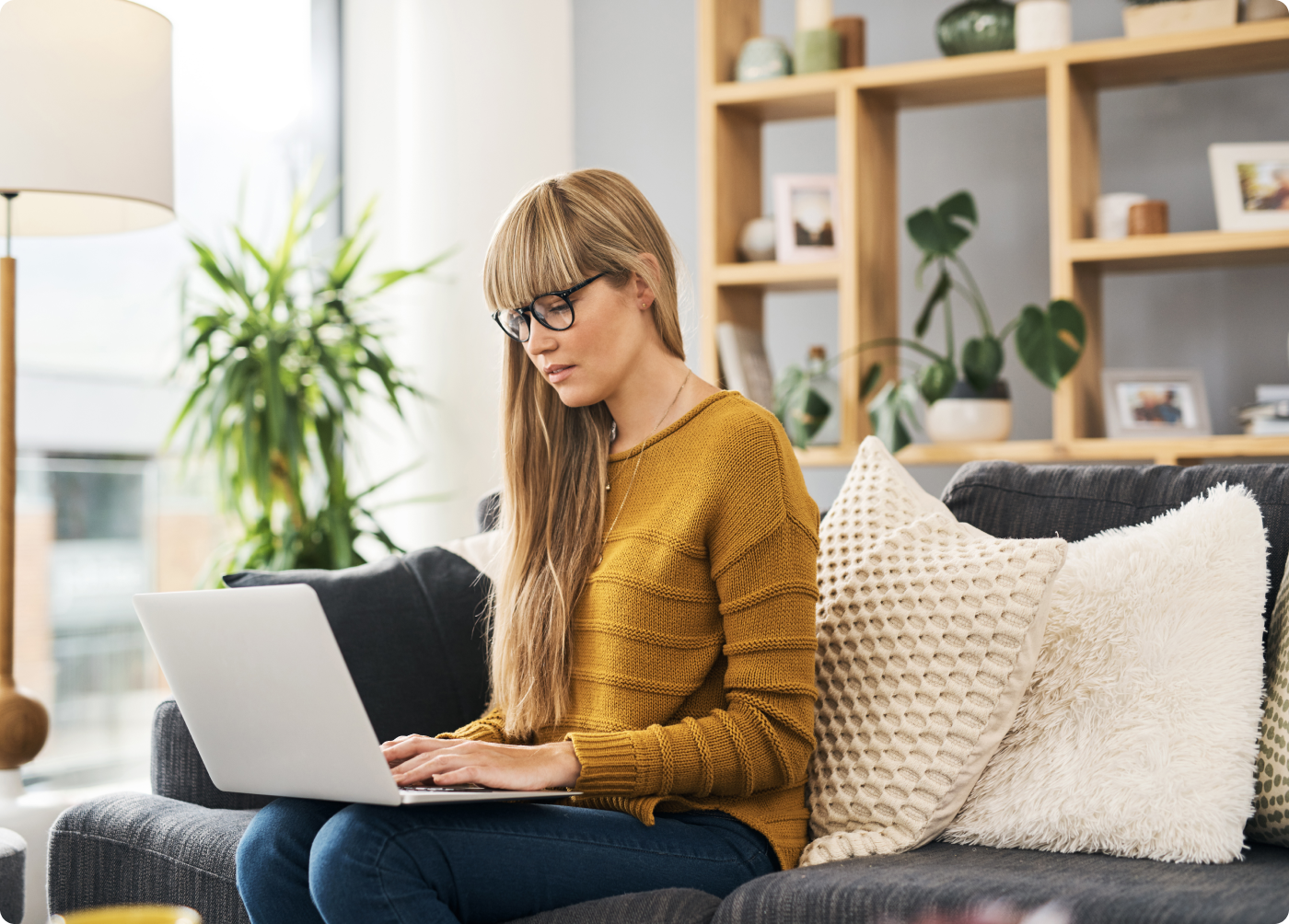 woman sitting on couch with laptop open