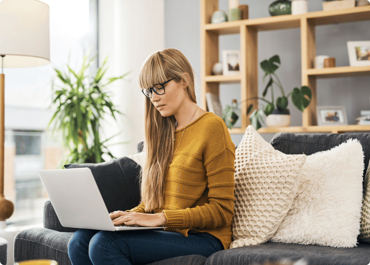 woman sitting on couch with laptop open