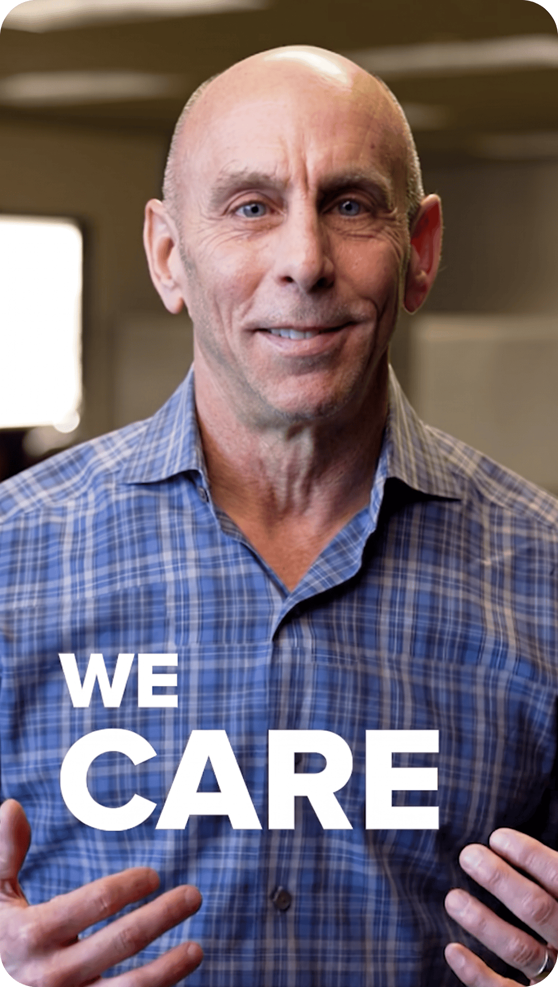 Person smiling with text that says "we care".