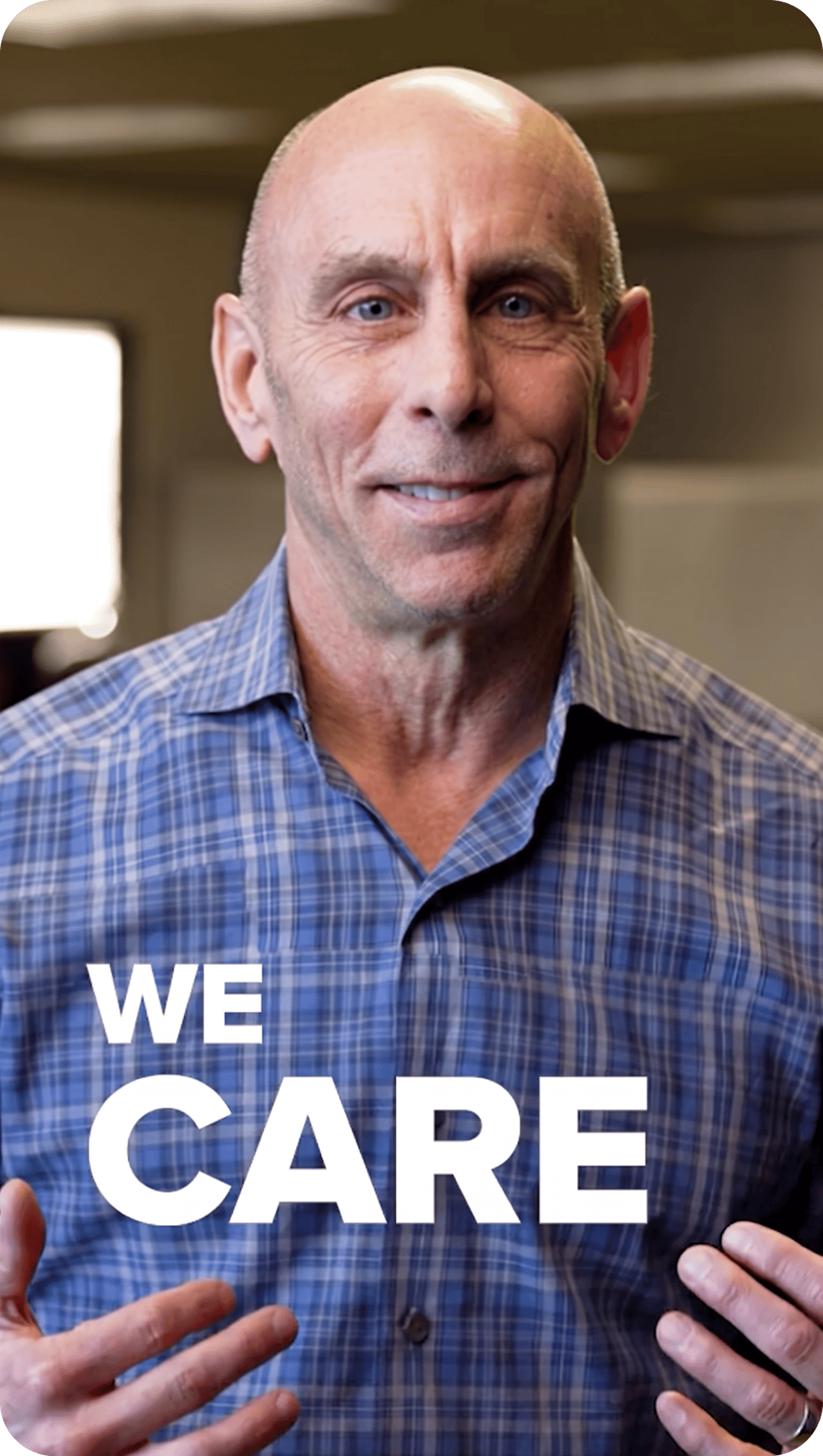 Person smiling with text that says "we care".