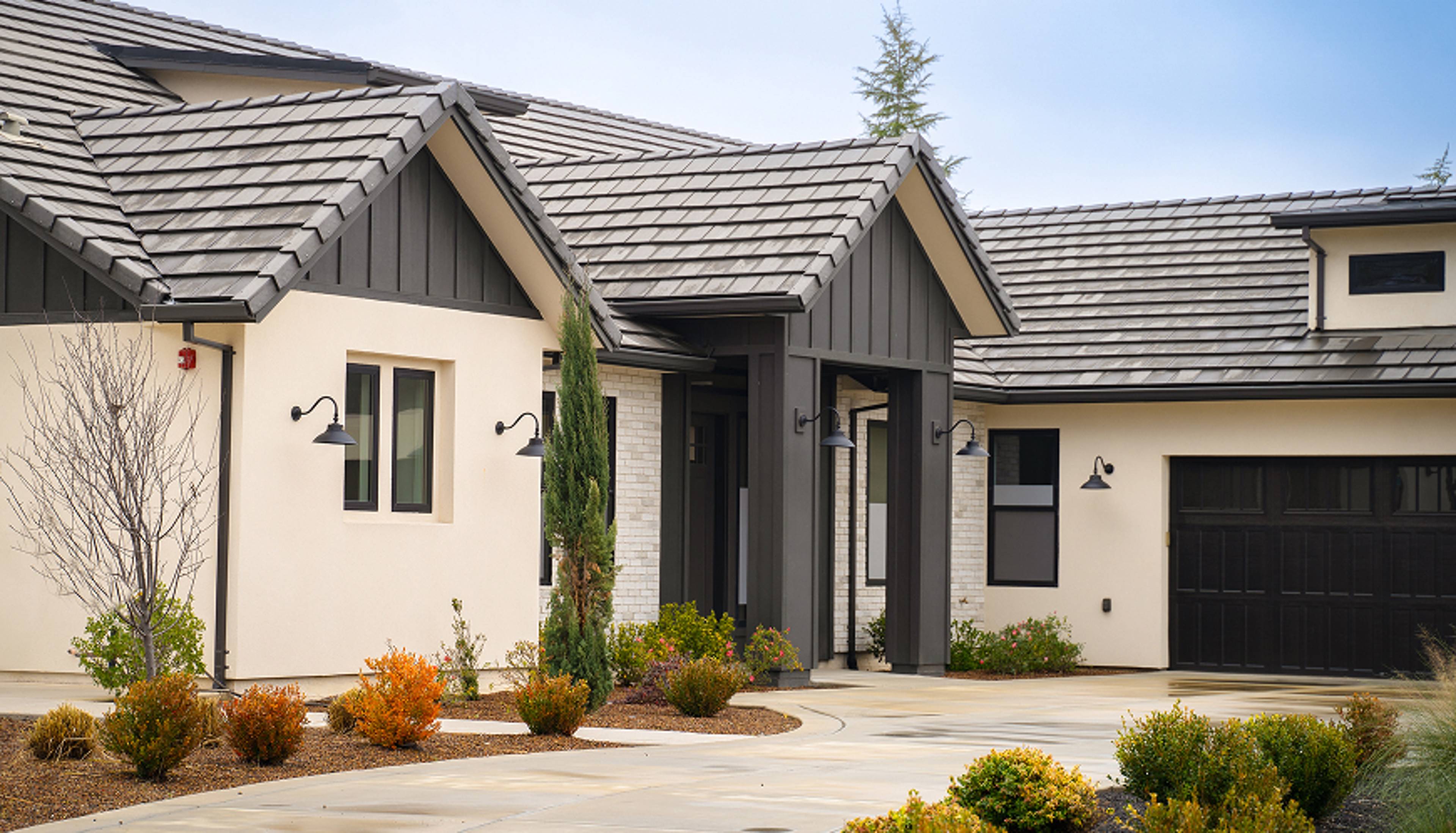 Single Story home with a cement driveway leading to the front foor.