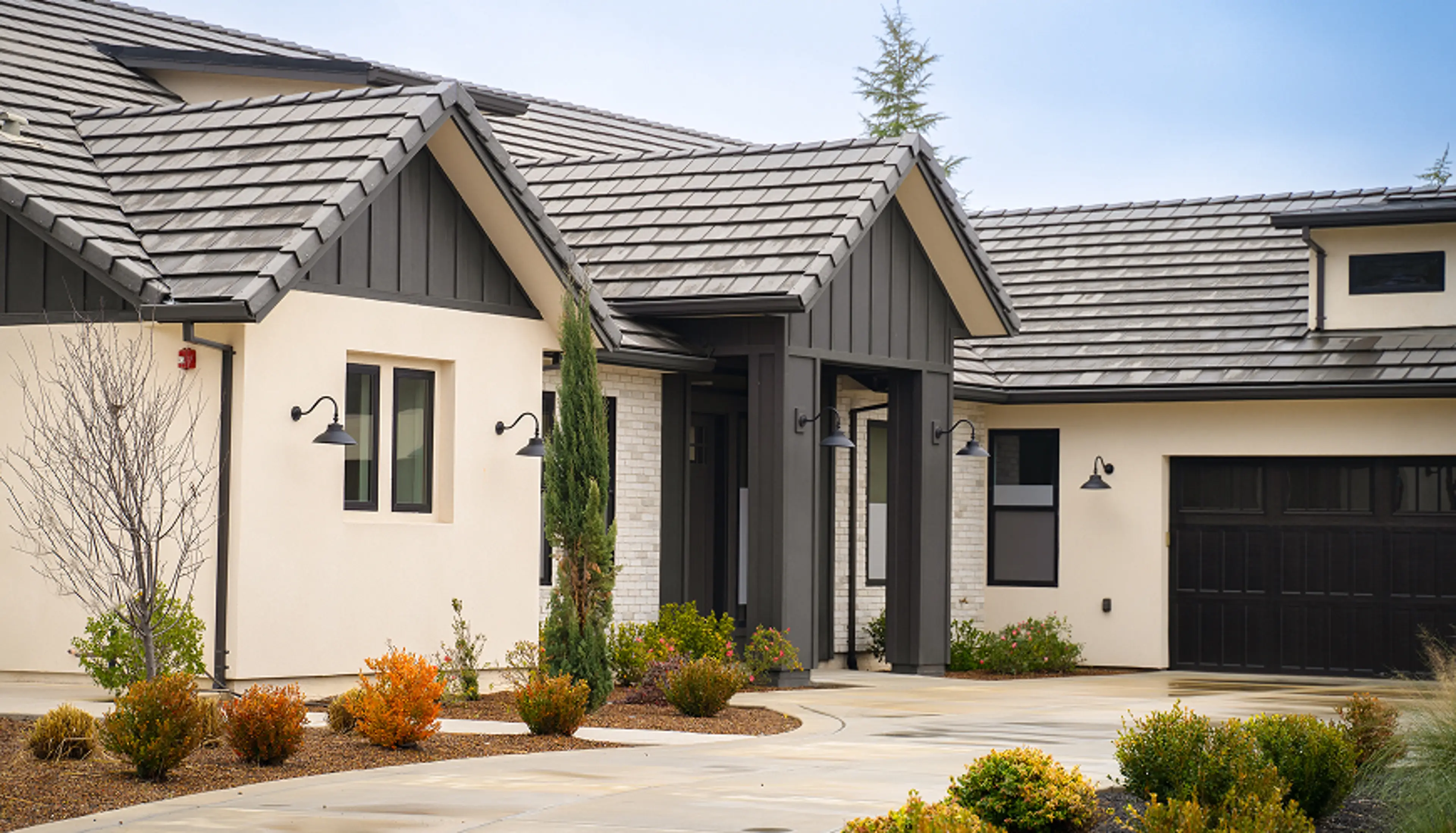 Single Story home with a cement driveway leading to the front foor.