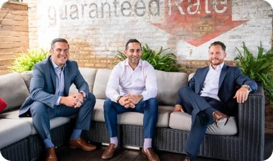 Three loan officers sitting on a sofa.