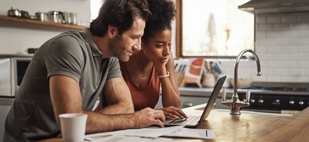 Couple looking at a laptop.