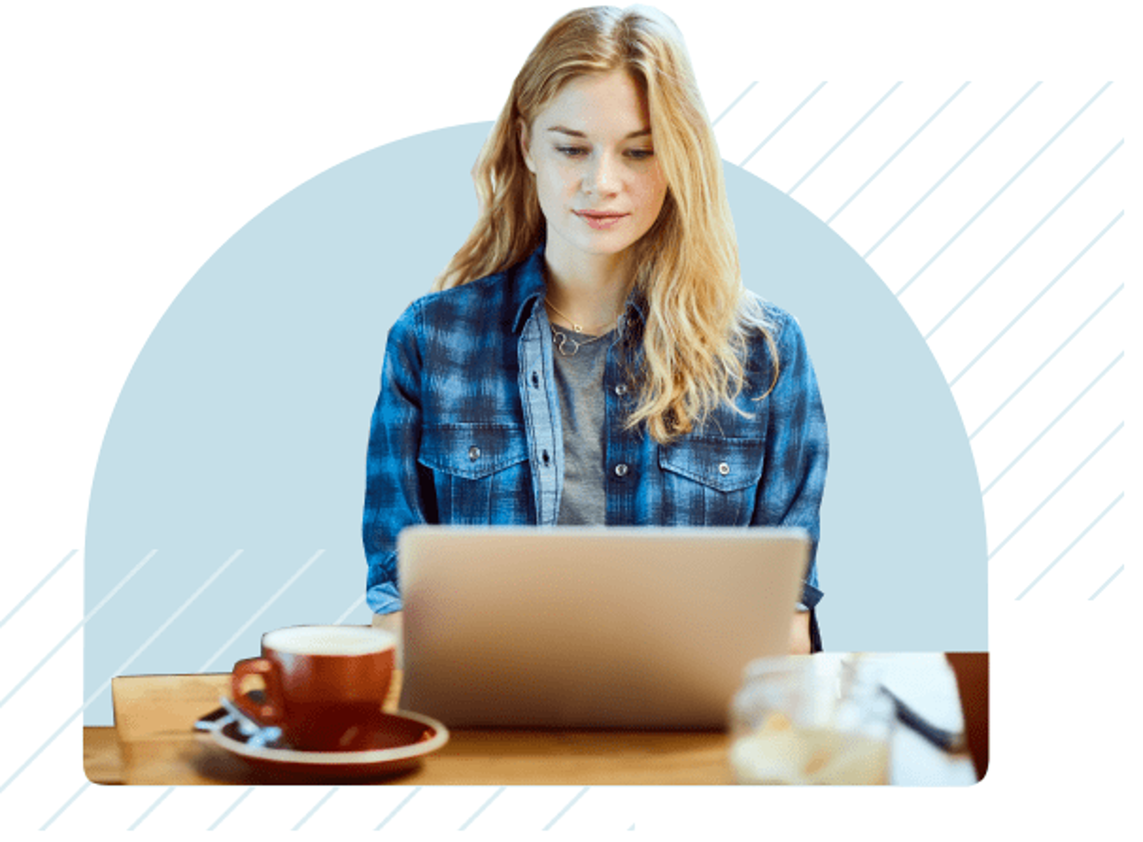 A person sits at a table using a laptop with a coffee cup to the side.