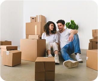 Couple sitting next to several moving boxes