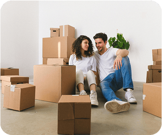 Couple sitting next to several moving boxes