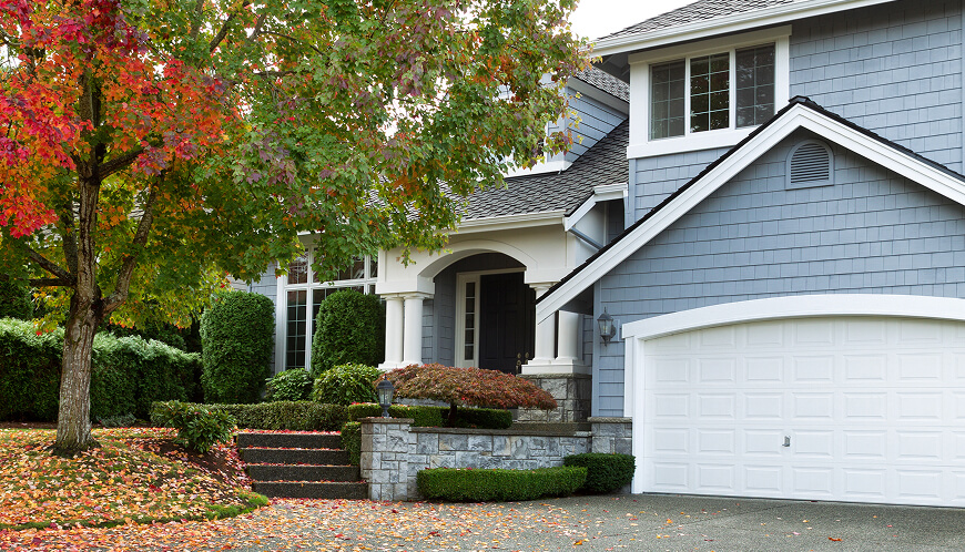 Blue house with fall leaves.
