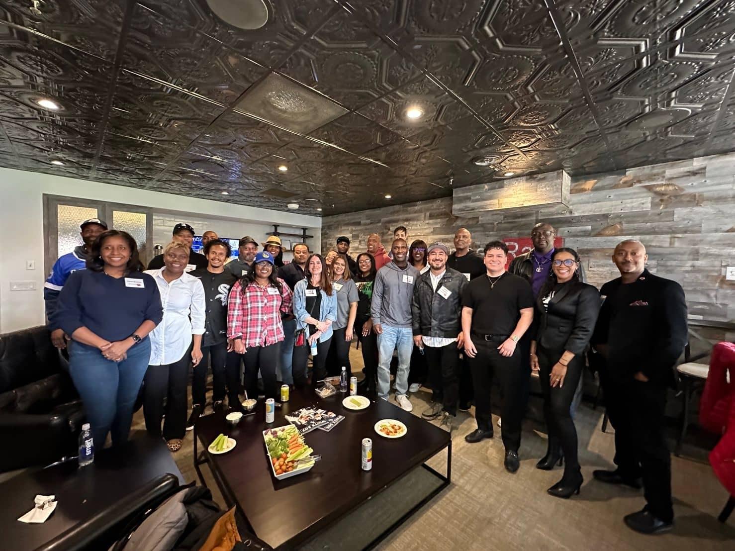Large group of LEAD members posing together in a lounge.