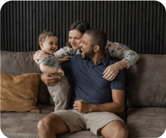 Excited couple and baby in a living room