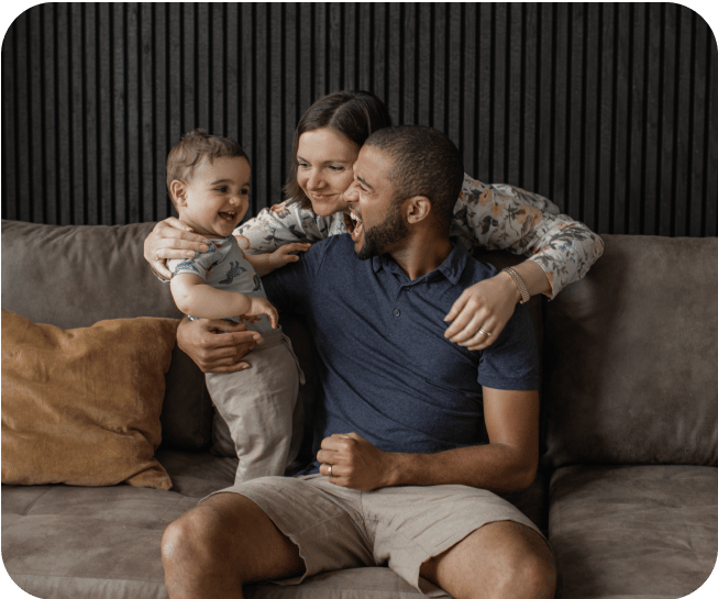 Excited couple and baby in a living room