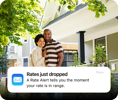 Couple outside their home receiving a mortgage rate alert