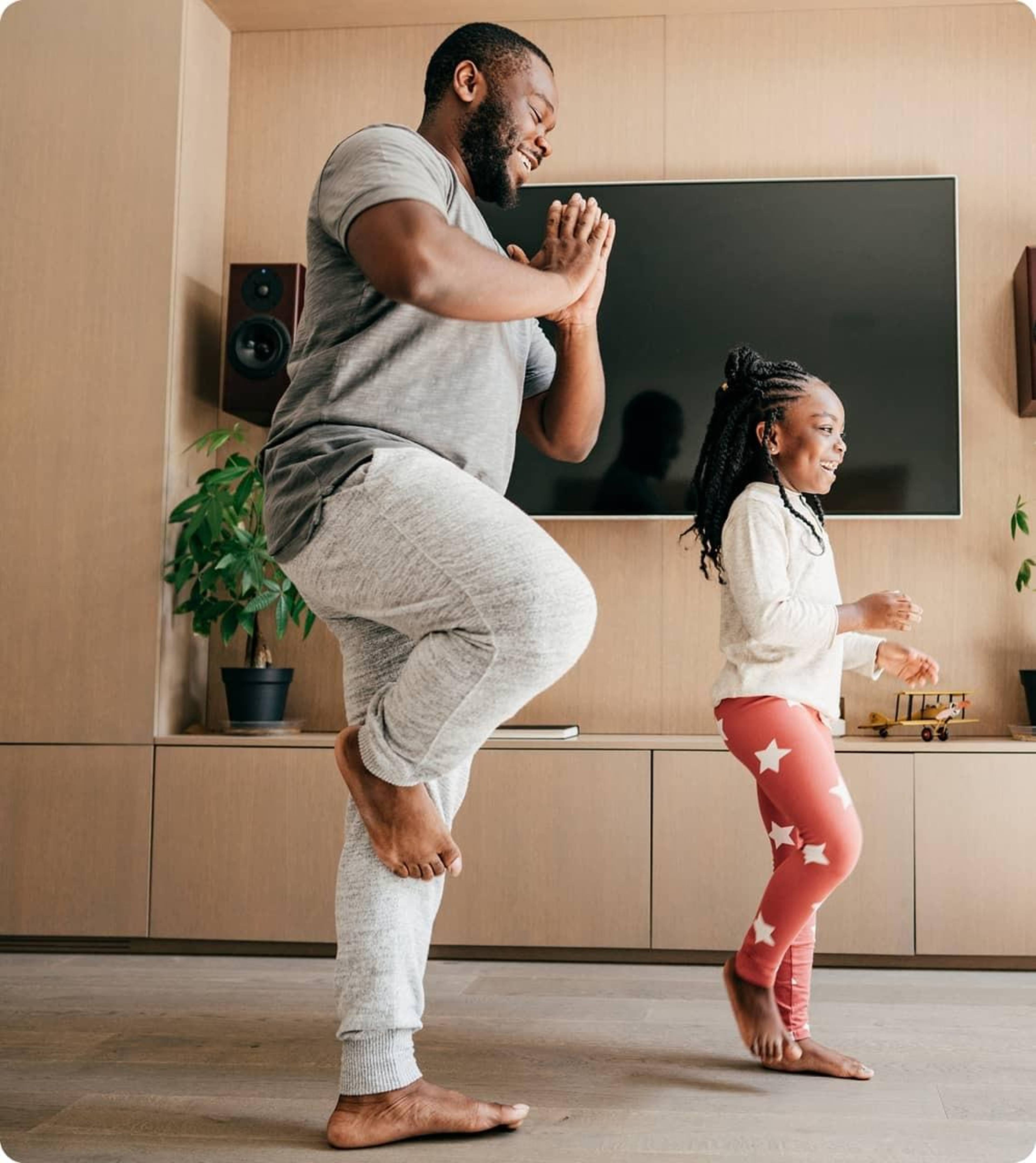 Dad and daughter doing tree pose