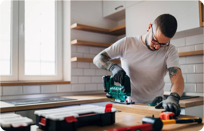 Man cutting piece of wood for a kitchen