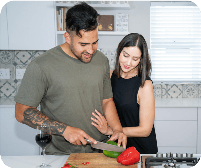 Couple chopping vegetables in the kitchen