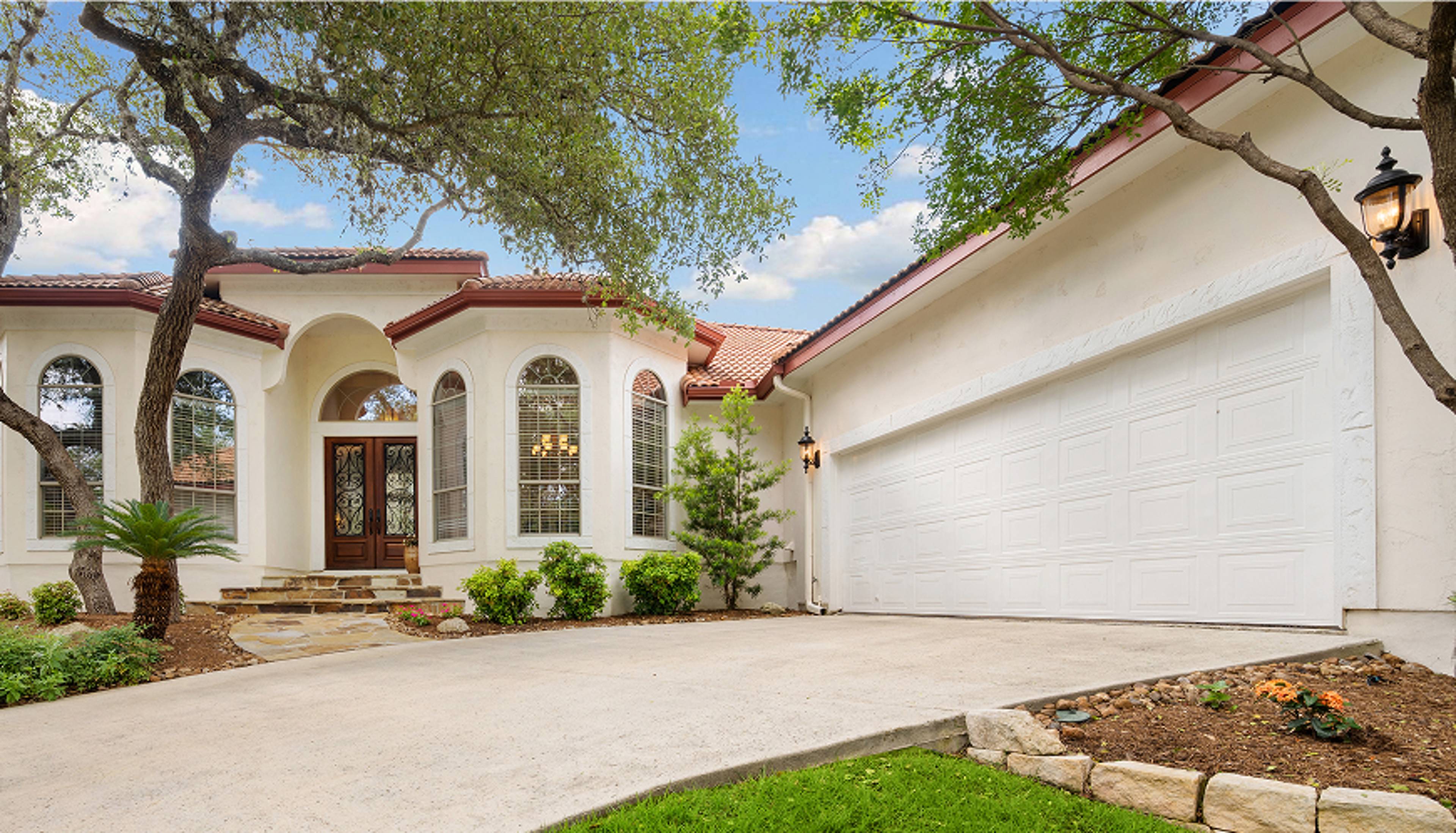 Home with a bay window connecting to a garage.