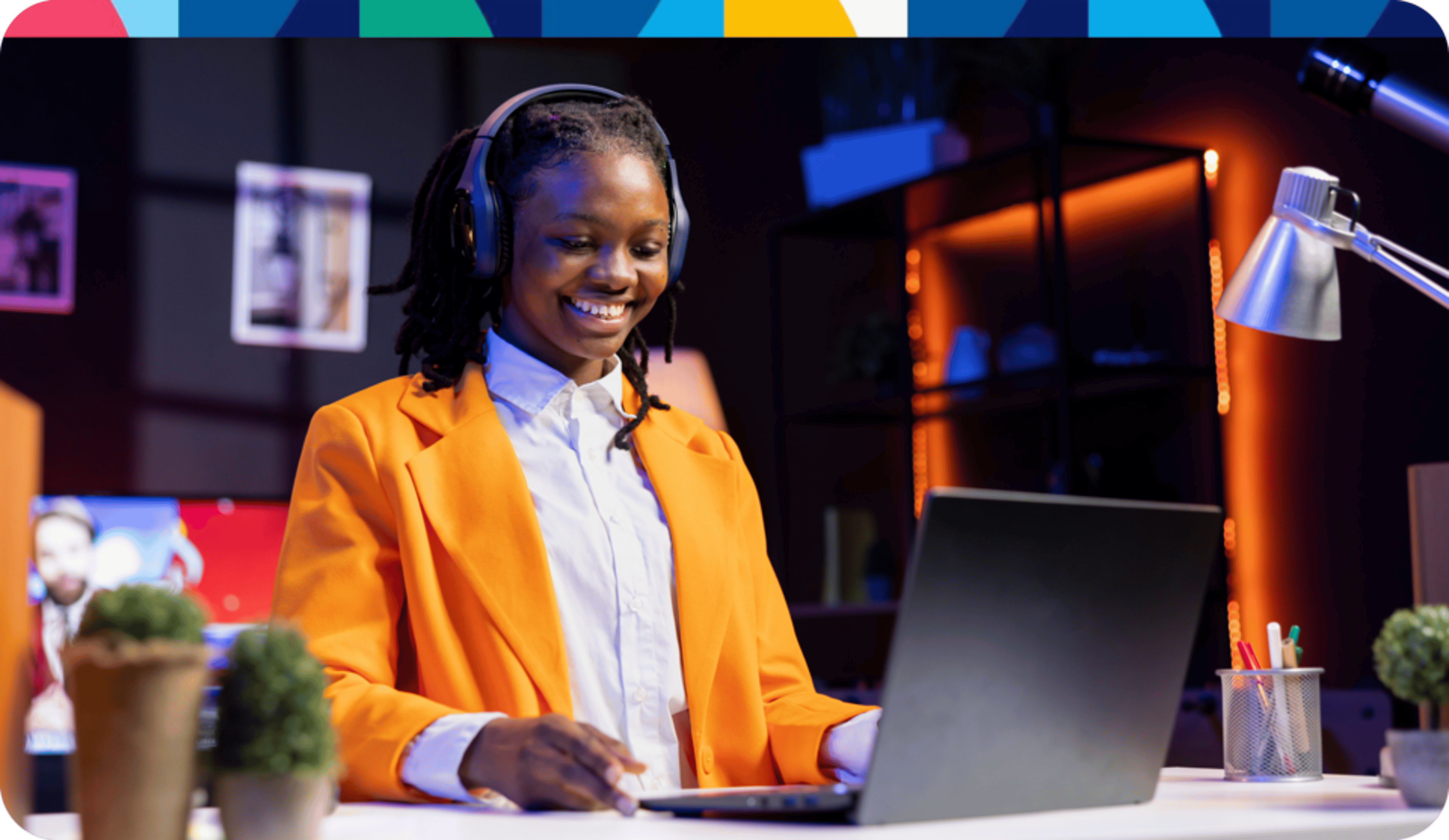 Woman with headphones on computer with festive top boarder