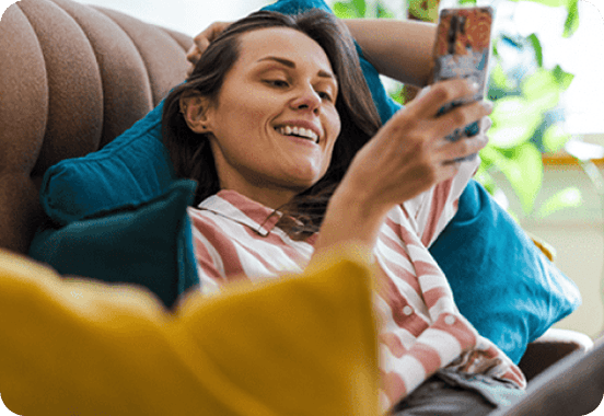 Girl sitting on a couch on her phone