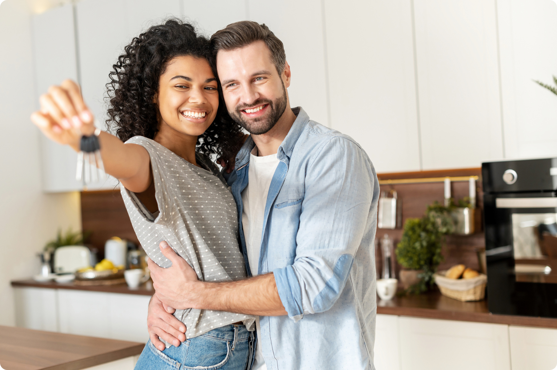 Couple holding keys to a home