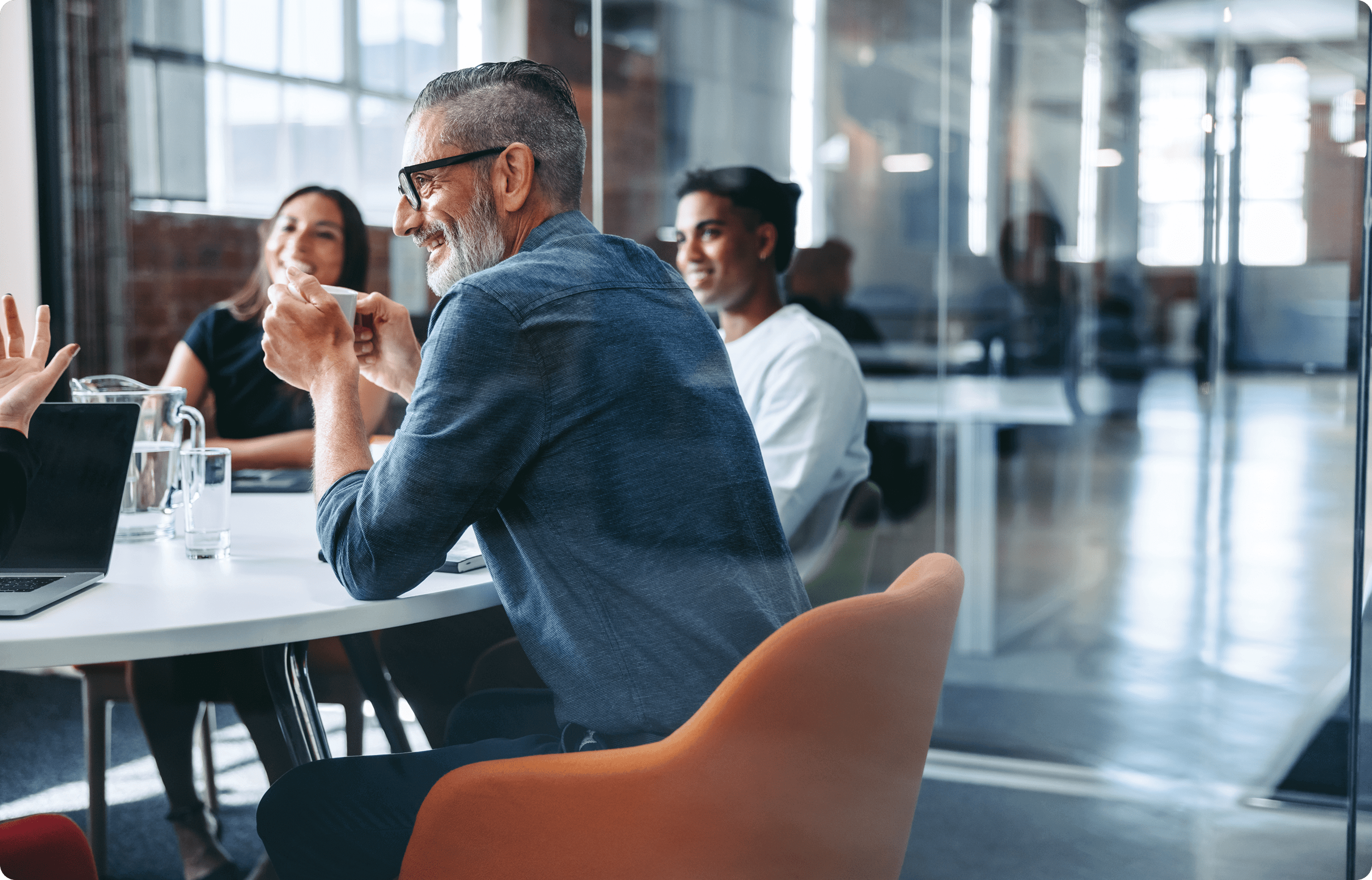 Rate Correspondent - Man in a meeting with others.