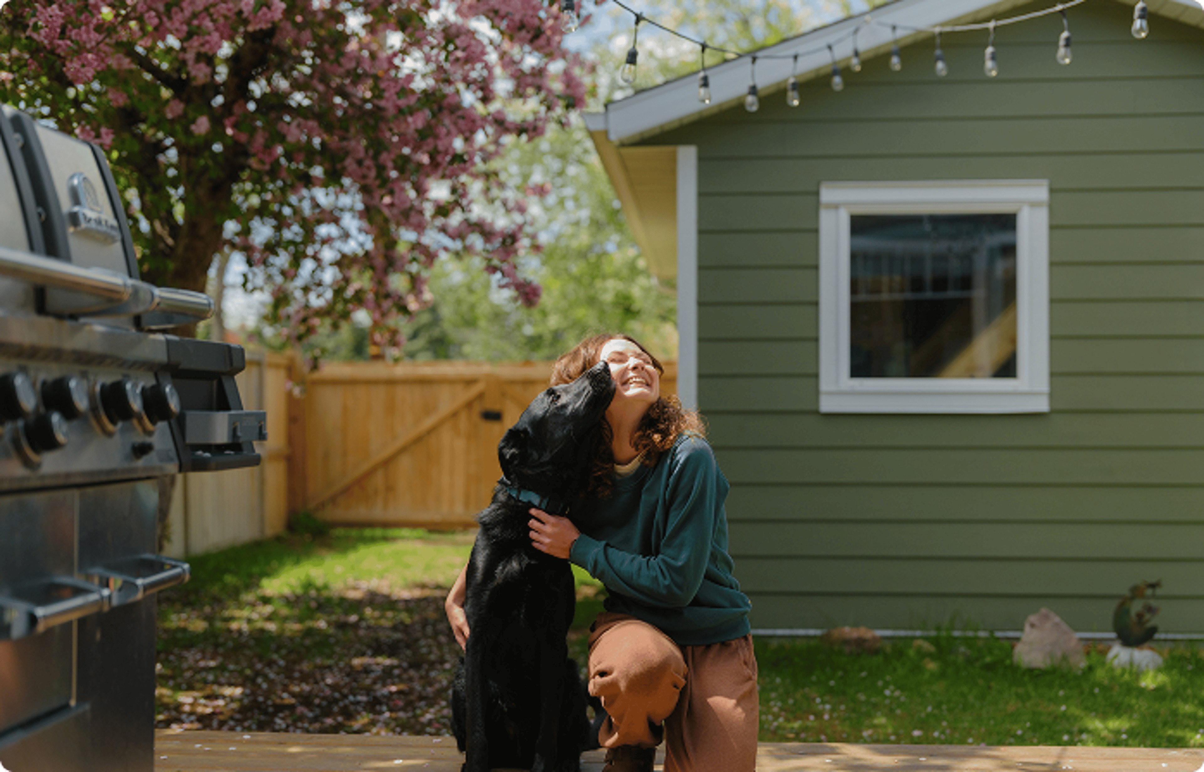 Woman with a dog in the backyard.