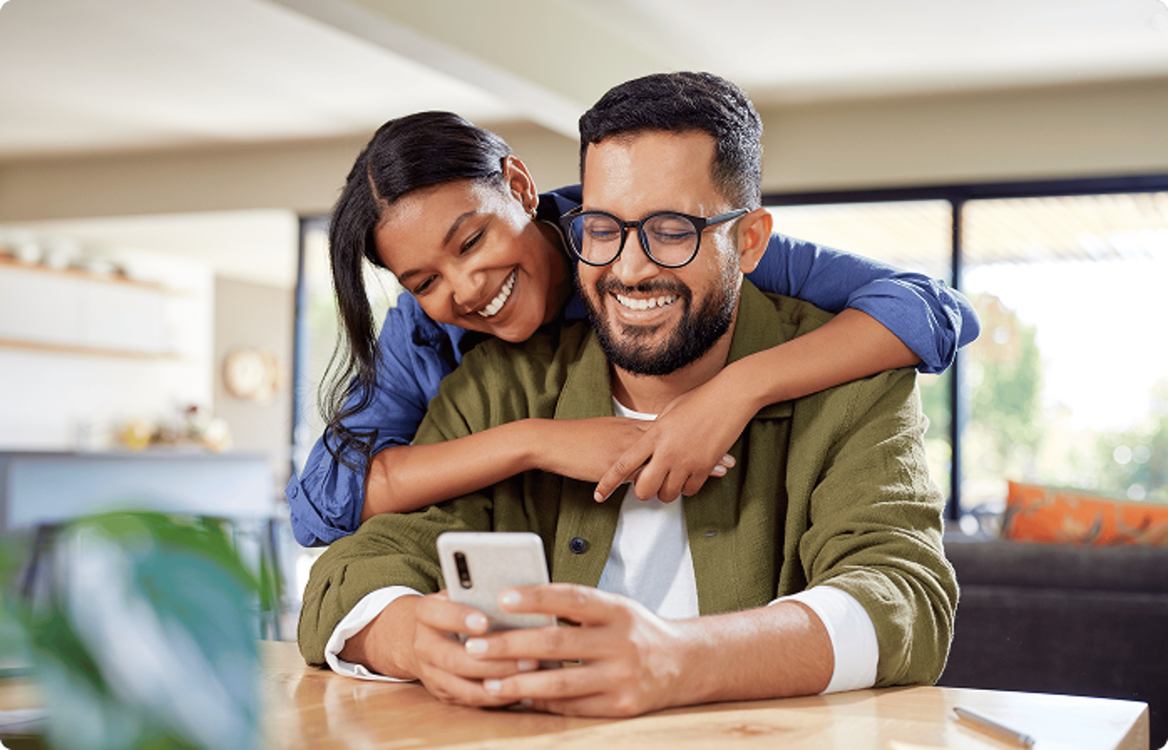 Rate Bridge - Couple hugging and looking at the phone.