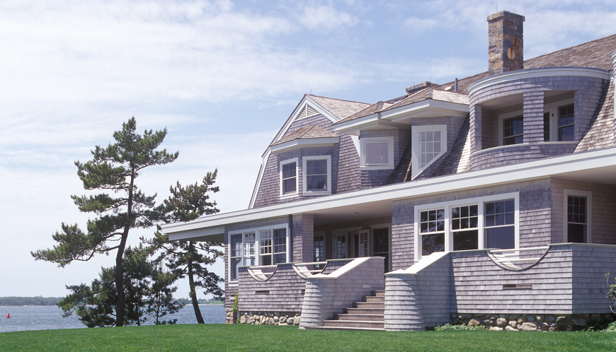 View of a house from the front yard with green grass.