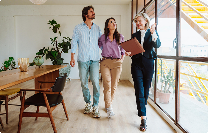 Couple being shown the inside of a house.