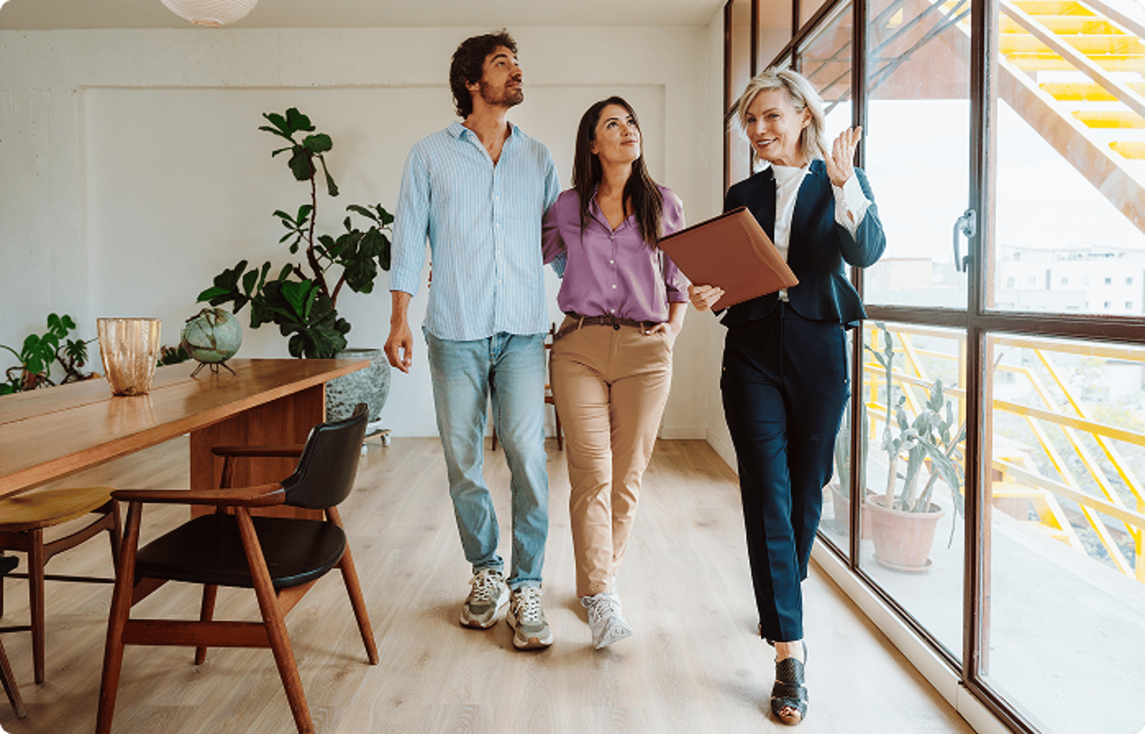 Couple being shown the inside of a house.