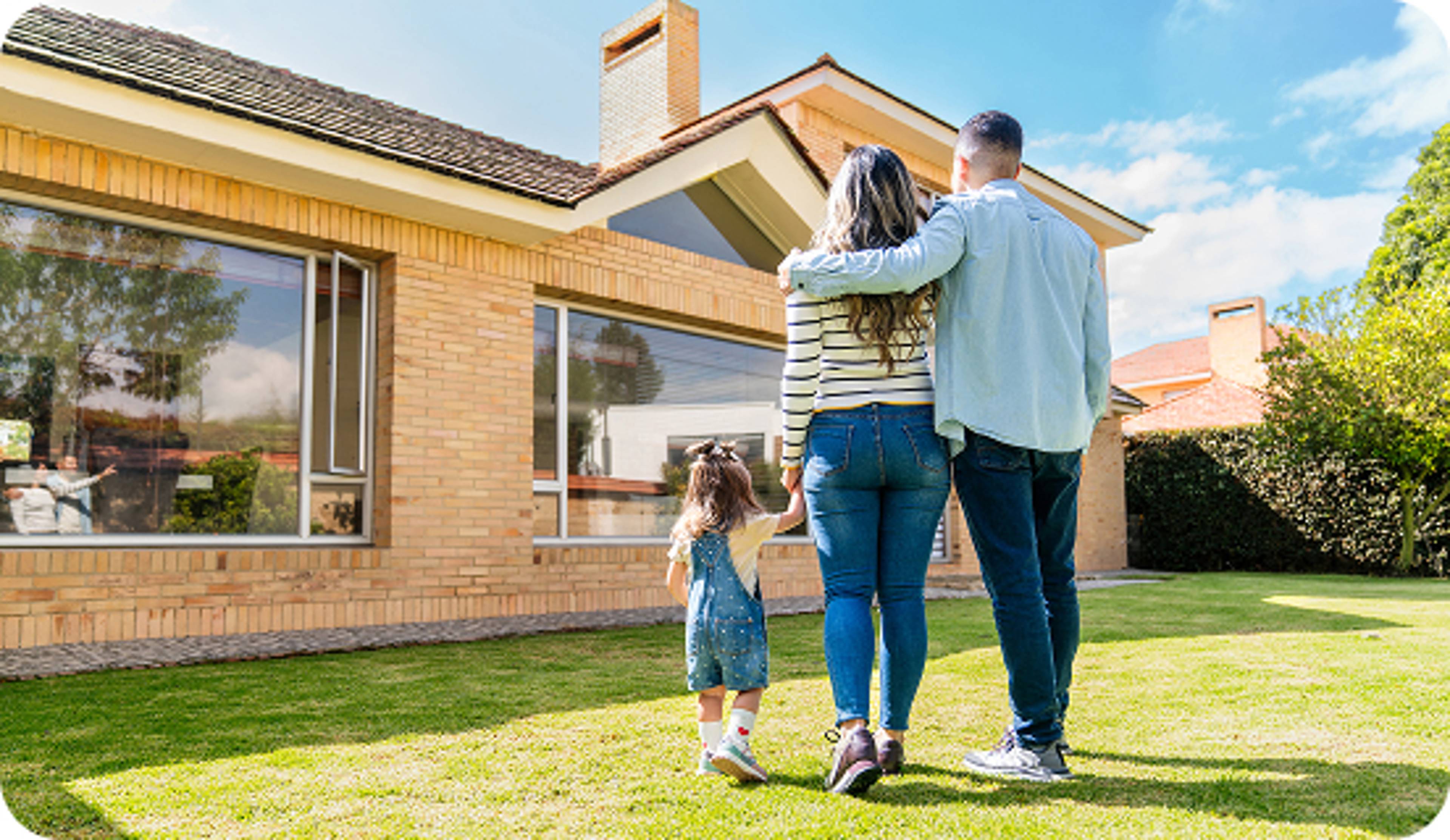 Family looking at their home in the backyard