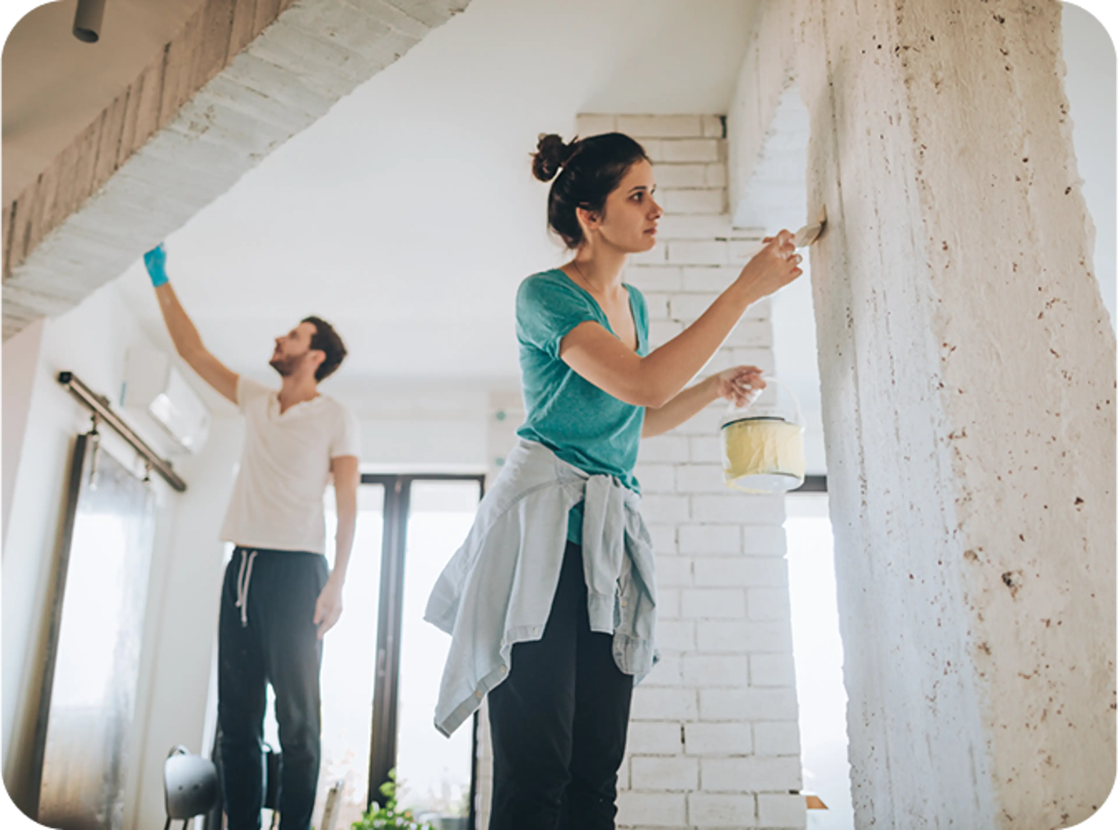Couple painting their walls and ceiling