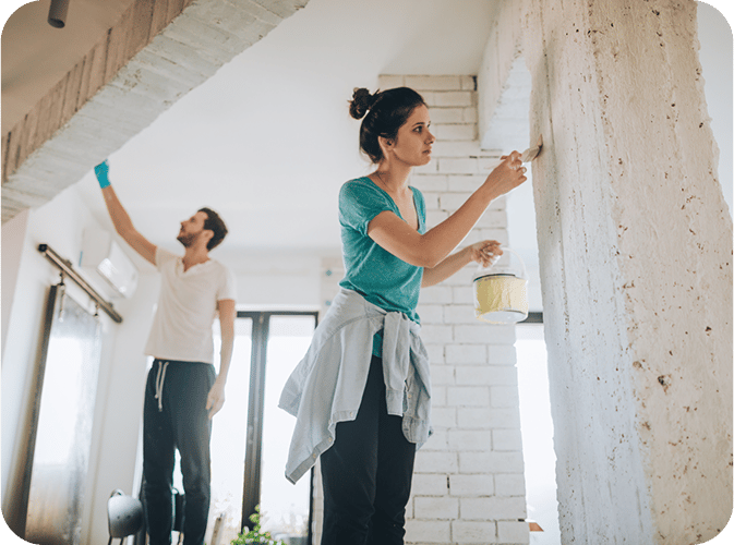 Couple painting their walls and ceiling