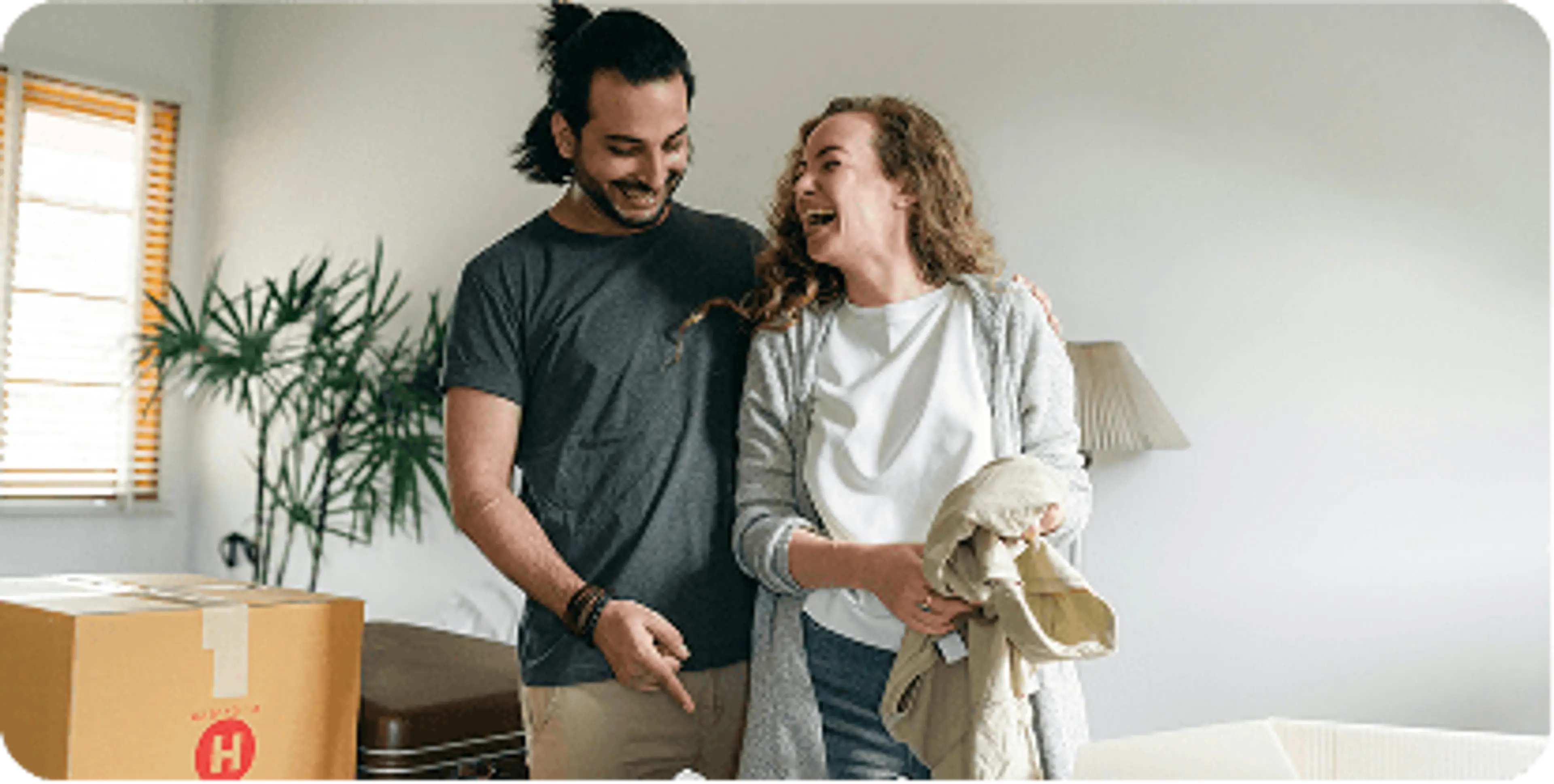 Couple laughing together in their home