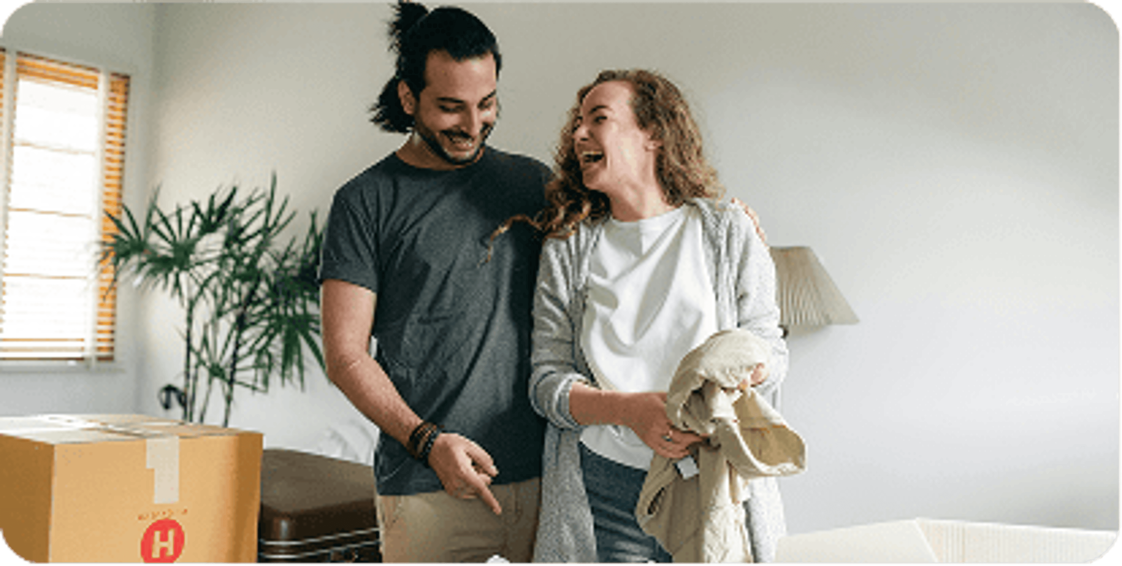 Couple laughing together in their home
