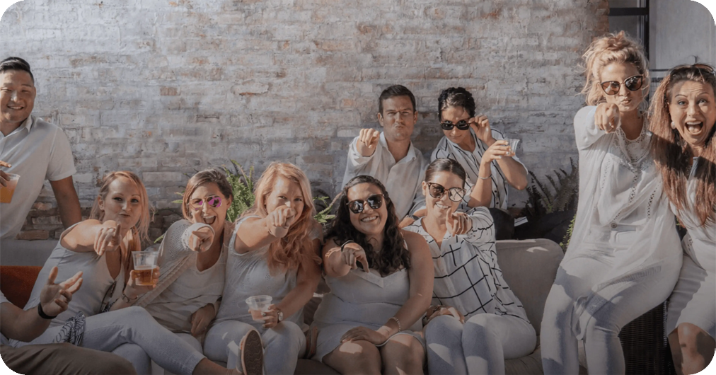 Members of the Rate team smiling and pointing at the camera.