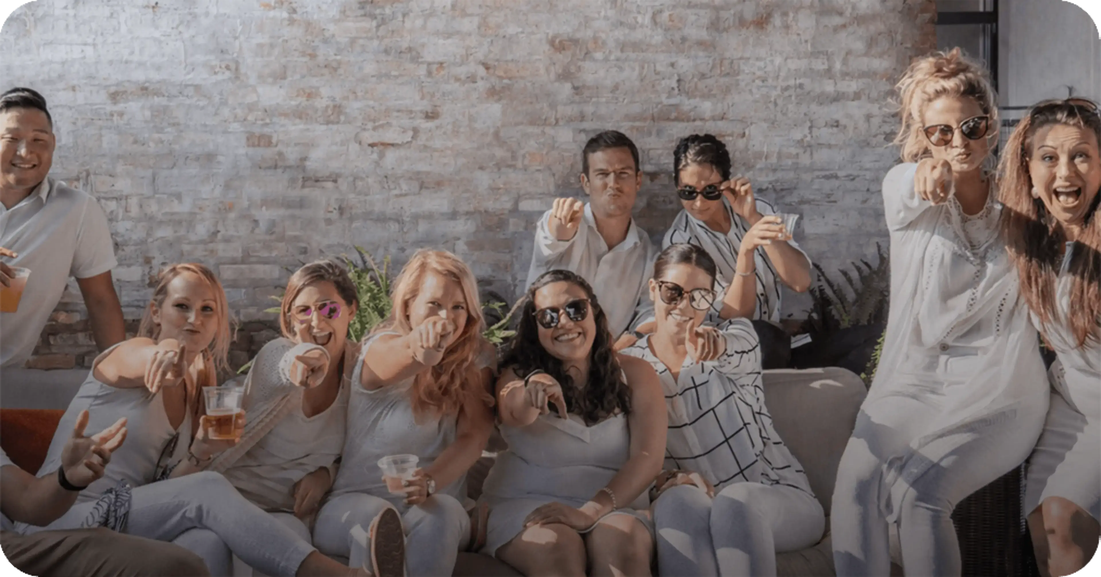 Members of the Rate team smiling and pointing at the camera.