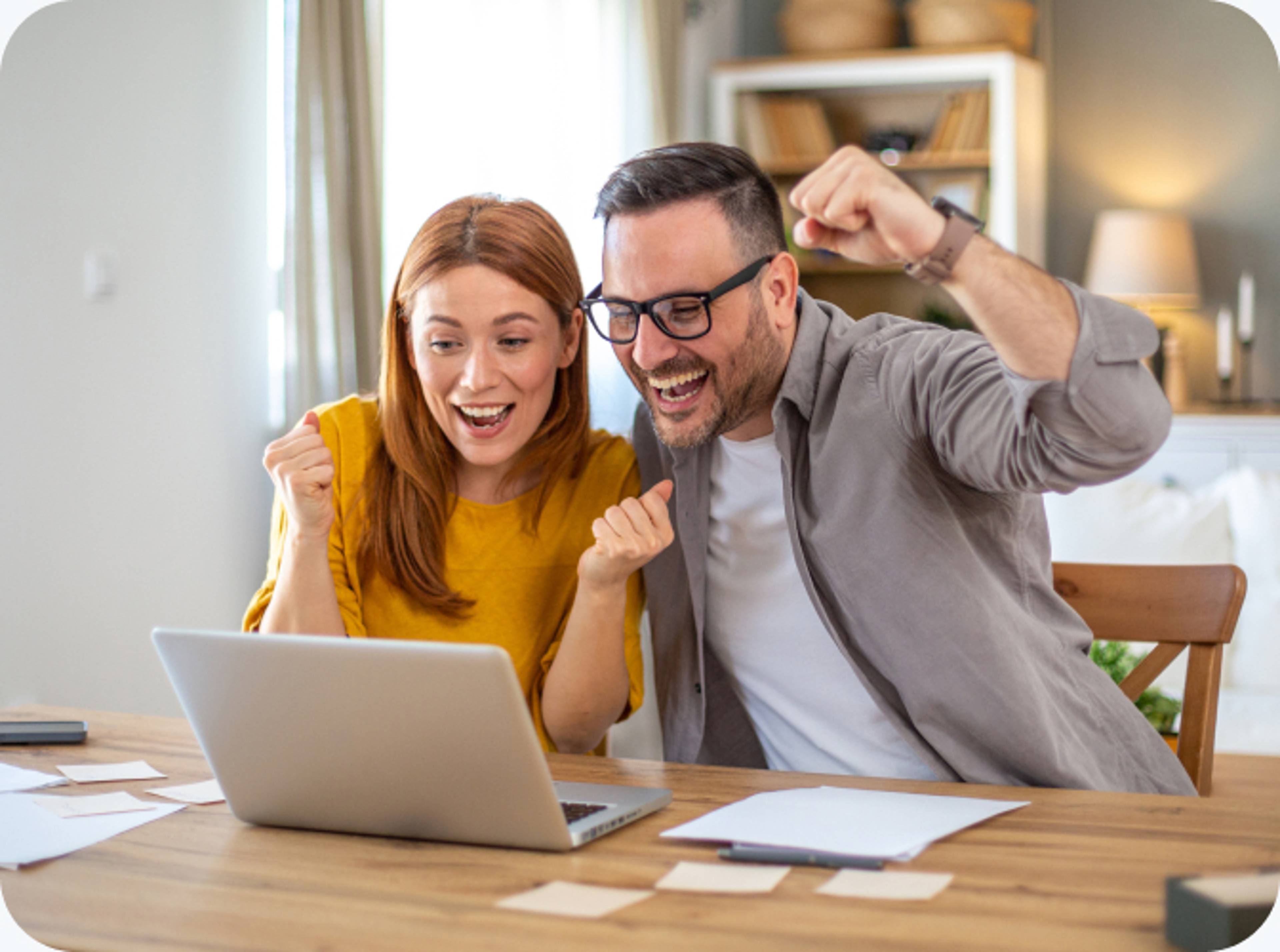 Man and women celebrating on a laptop