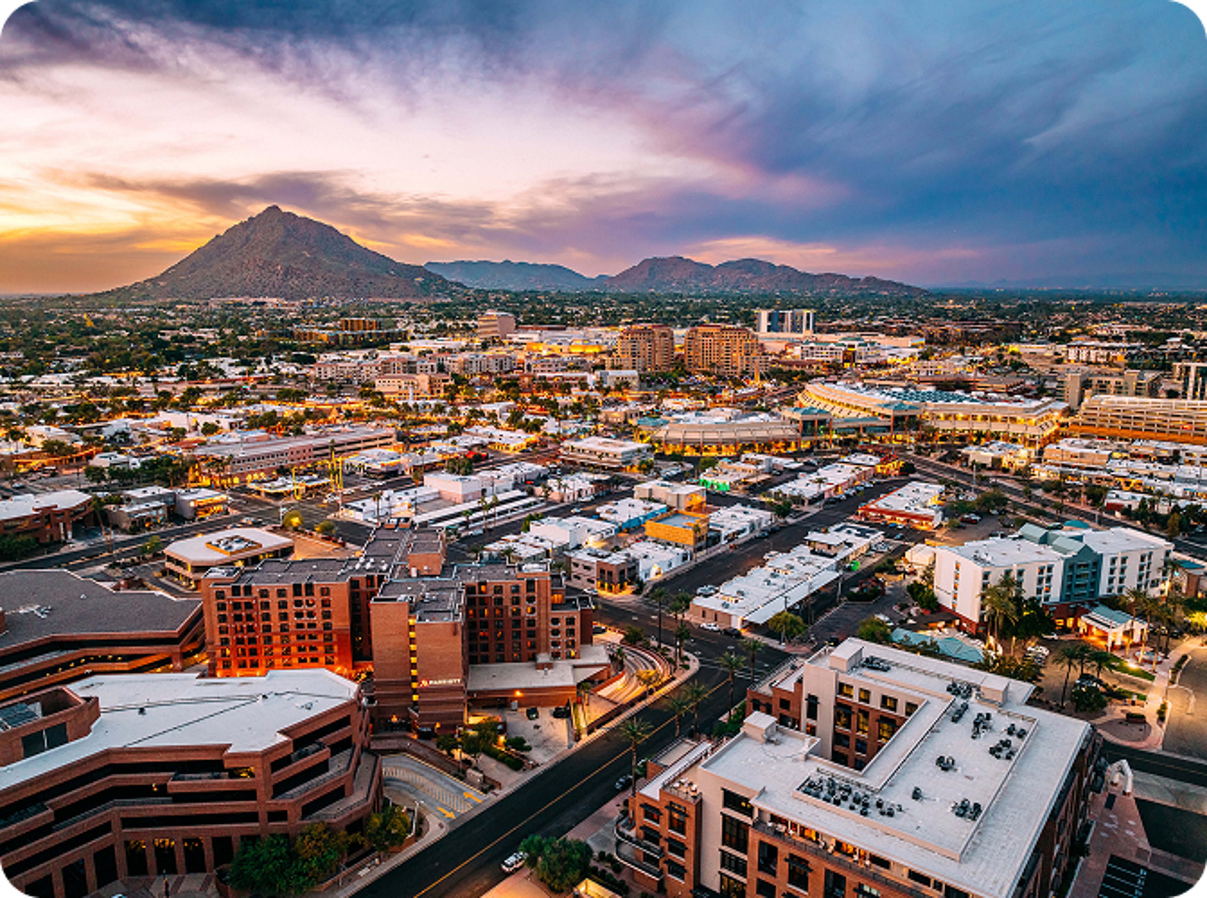 Arizona houses from above with a mountain in the distance.