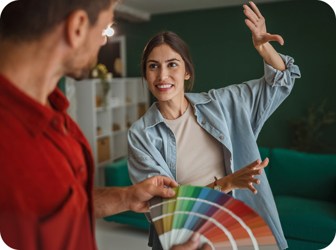 Man and woman looking at different paint colors.