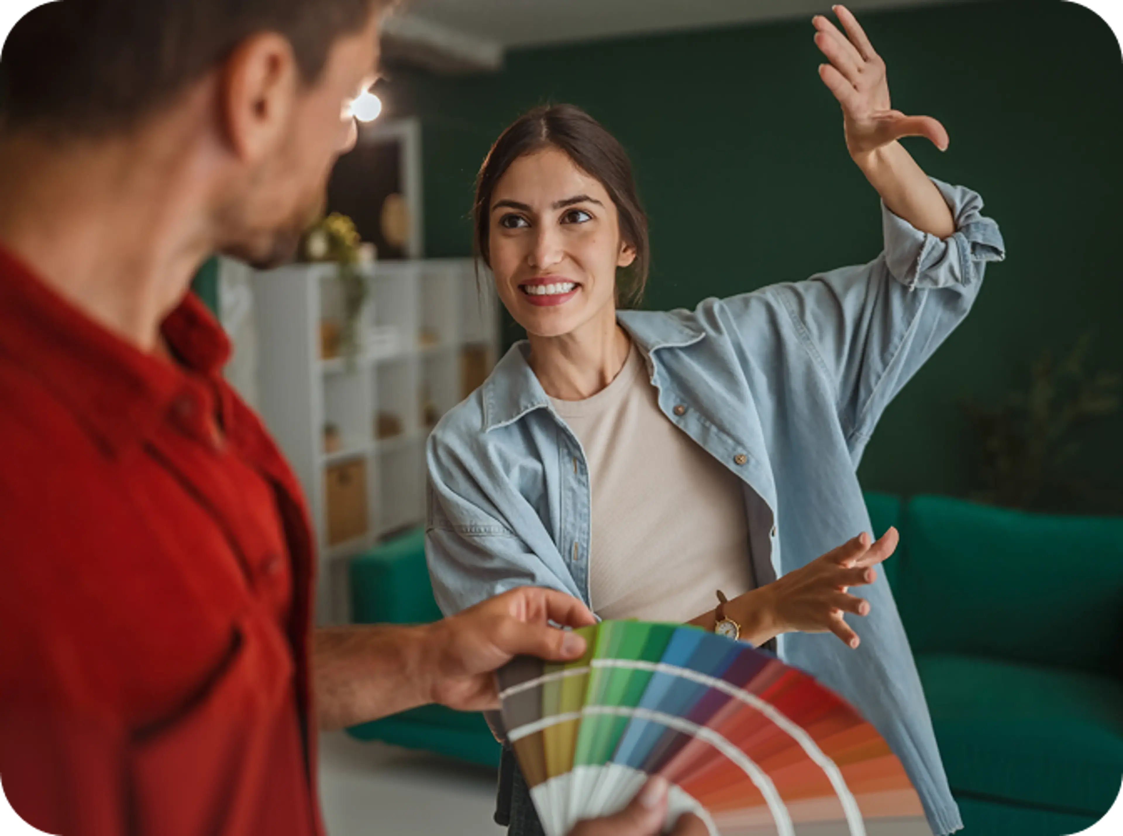 Man and woman looking at different paint colors.