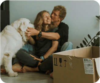 Couple and dog sitting on the floow